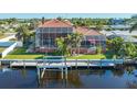 Back view of home showcasing canal access and a private dock at 108 Roselle Ct, Port Charlotte, FL 33952
