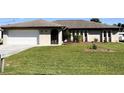 Single-story house with attached garage and well-maintained lawn at 1196 Hinton St, Port Charlotte, FL 33952