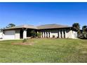 Single story house with a two-car garage and landscaped yard at 1196 Hinton St, Port Charlotte, FL 33952