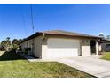 Attached garage with white door and ample space at 1196 Hinton St, Port Charlotte, FL 33952