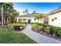 Inviting home exterior with landscaped walkway leading to entrance at 17513 Pomegrante Way, Punta Gorda, FL 33955