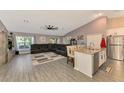 Spacious living room with a large sectional sofa, and kitchen island at 1858 Capitol St, North Port, FL 34288