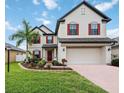 Two-story house with red shutters, paver driveway, and landscaping at 2084 La Palma Ave, Port Charlotte, FL 33953