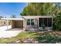 Quaint house with carport and a screened porch at 2112 Mark Ave, Punta Gorda, FL 33950