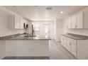 Bright kitchen with white cabinets, granite counters, and stainless steel appliances at 27152 Monte Cristo Blvd, Punta Gorda, FL 33955