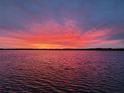 Stunning sunset over calm water at 3220 Peace River Dr, Punta Gorda, FL 33983
