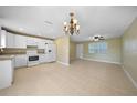 Modern kitchen with white cabinets, granite countertops, and stainless steel appliances at 511 Corto Andra St, Punta Gorda, FL 33950
