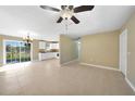 Bright living room featuring tile flooring and a ceiling fan at 511 Corto Andra St, Punta Gorda, FL 33950