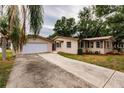 Tan single-story home with attached garage and a long driveway at 515 W Olympia Ave, Punta Gorda, FL 33950