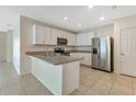 Modern kitchen with stainless steel appliances and an island at 7081 Crystal Way, Punta Gorda, FL 33950