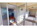 View of home's interior from screened front entryway with glass adorned door at 1 Colony Point Dr # 16C, Punta Gorda, FL 33950