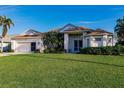 Two-story house with a large yard and palm trees at 17347 Lake Worth Blvd, Port Charlotte, FL 33948