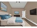 Comfortable bedroom featuring a king-size bed, plush pillows, and a large wall-mounted television at 2387 Tamarind St, Port Charlotte, FL 33948