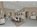 Open-concept dining area with modern lighting, sleek marble floors, and a view to the kitchen at 2387 Tamarind St, Port Charlotte, FL 33948