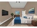 Spacious main bedroom features a king bed, a wall-mounted TV, and complementary wall art at 2387 Tamarind St, Port Charlotte, FL 33948