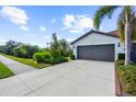 Exterior of a house with a two-car garage and driveway at 2481 Daisy Dr, North Port, FL 34289