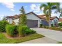 Front view of a two-story house with a two-car garage at 2481 Daisy Dr, North Port, FL 34289