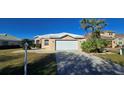 Single-story house with a white roof and garage at 26159 Stillwater Cir, Punta Gorda, FL 33955