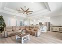 Bright living room with sectional sofa, coffee table, and Christmas tree at 23071 Mineral Ave, Port Charlotte, FL 33954