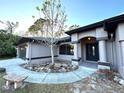 House entrance with columns, landscaping, and a walkway at 2913 Rufus Rd, North Port, FL 34288