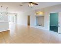 Open floor plan featuring tile flooring, neutral walls, and a view into the kitchen and beyond at 3097 Royal Palm Dr, North Port, FL 34288