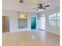 Bright living room with tile flooring, a ceiling fan, and a built-in alcove for entertainment at 3097 Royal Palm Dr, North Port, FL 34288