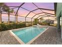 Relaxing screened-in pool and spa with a patio area at 43660 Tree Top Trl, Punta Gorda, FL 33982