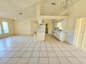 Open concept living room and kitchen with tile flooring at 6222 Berkeley St, Englewood, FL 34224