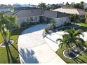 An aerial view showcasing a single-Gathering home's exterior, landscaping, and driveway at 726 Macedonia Dr, Punta Gorda, FL 33950
