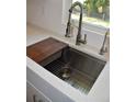 Modern kitchen sink with a butcher block cutting board and stainless steel fixtures at 11278 4Th Ave, Punta Gorda, FL 33955