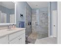 This bathroom features a glass enclosed shower with stone floor and built-in shelf at 1205 Bartlett Ave, North Port, FL 34288
