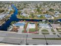 Bird's eye view of a single story home with a pool and spacious lot at 21062 Edgewater Dr, Port Charlotte, FL 33952