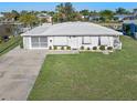 White single story home with attached garage and manicured lawn at 21062 Edgewater Dr, Port Charlotte, FL 33952