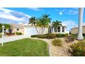 Well-maintained house with lush landscaping and a two-car garage at 26247 Stillwater Cir, Punta Gorda, FL 33955