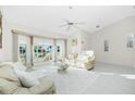 Bright living room with large windows, tile flooring, and neutral decor at 279 Mariner Ln, Rotonda West, FL 33947