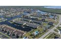 Wide aerial view showing condo building, tennis court, and waterway at 4000 Bal Harbor Blvd # 126, Punta Gorda, FL 33950