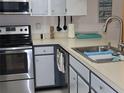 Galley kitchen with stainless steel appliances and light blue cabinets at 4048 Oakview Dr # F2-3, Punta Gorda, FL 33980