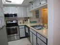 Stainless steel appliances and light blue cabinets in a galley kitchen at 4048 Oakview Dr # F2-3, Punta Gorda, FL 33980