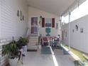 Covered patio with seating area and decorative items at 6546 Greenview Ct, North Port, FL 34287