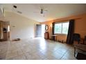 Living room with tiled floors, a ceiling fan, and several windows at 11332 8Th Ave, Punta Gorda, FL 33955