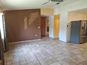 Spacious living room featuring tile flooring, a ceiling fan, and neutral paint palette at 11332 8Th Ave, Punta Gorda, FL 33955