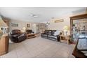 Spacious living room with leather sofas and a tile floor at 1437 Rommel St, Port Charlotte, FL 33952