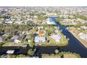 An aerial shot showing a house nestled on a waterway, offering water access and neighborhood context at 3004 Banyan Way, Punta Gorda, FL 33950