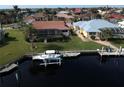 View of waterfront homes from the canal, featuring private docks and screened lanais at 3448 Nighthawk Ct, Punta Gorda, FL 33950
