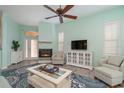 Living room with fireplace, light walls, and comfy seating at 10494 Princess Ct, Punta Gorda, FL 33955