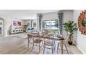 Charming dining area with wooden table and chairs, adjacent to the living room at 1428 Powell Valley Dr, Port Charlotte, FL 33953