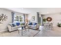 Bright living room features a comfortable sofa, coffee table and dining area at 1428 Powell Valley Dr, Port Charlotte, FL 33953