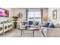 Spacious living room with large window, comfy seating, and stylish decor at 1428 Powell Valley Dr, Port Charlotte, FL 33953