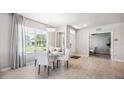 Bright dining area with white chairs and a round dining table at 2051 Royal Tern Cir, Punta Gorda, FL 33983