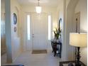 Bright and airy entryway with a console table and mirror at 25115 Esmeralda Ct, Punta Gorda, FL 33955